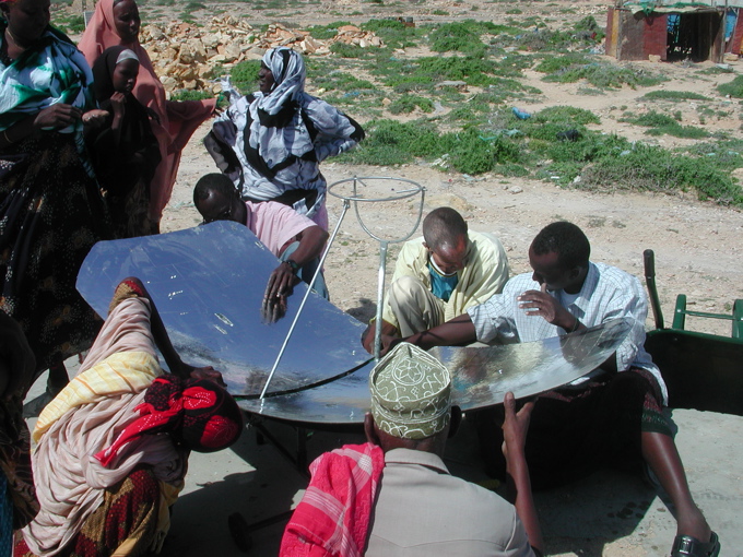 Man cooking with a solar cooker